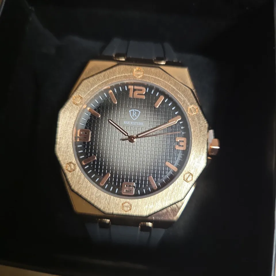 RUCKSTUHL BLACK RUBBER STRAP WRISTWATCH WITH ROSE GOLD COLOUR FRAME AND BLACK/SILVER COLOUR FACE