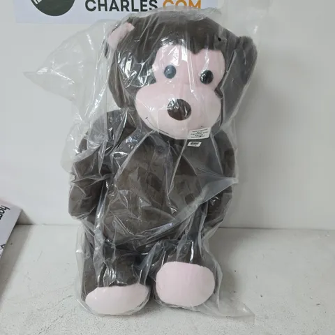 BROWN PLUSH MONKEY TOY IN CLEAR PLASTIC PACKAGING