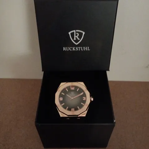 RUCKSTUHL GOLD COLOUR WRISTWATCH WITH BLACK RUBBER STRAP