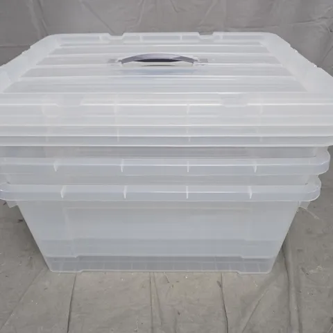 STACK OF CLEAR PLASTIC STORAGE BOXES WITH LIDS