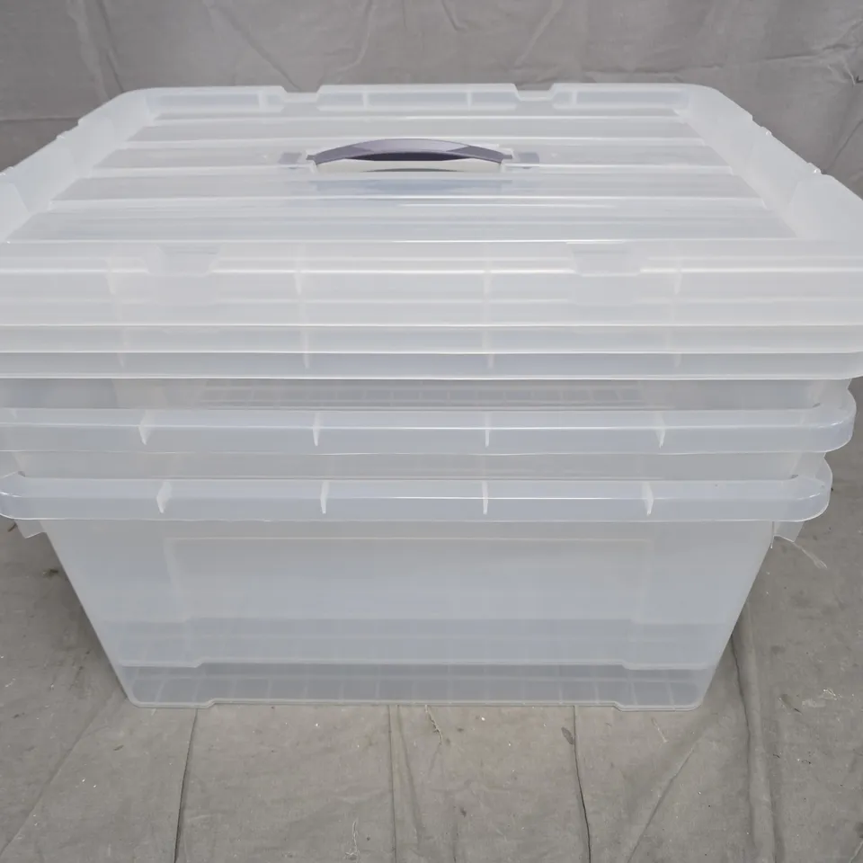STACK OF CLEAR PLASTIC STORAGE BOXES WITH LIDS