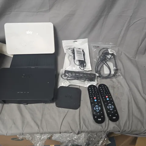 APPROXIMATELY 25 ASSORTED ELECTRICAL ITEMS TO INCLUDE SKY TV REMOTES, WIFI ROUTERS, CABLES.