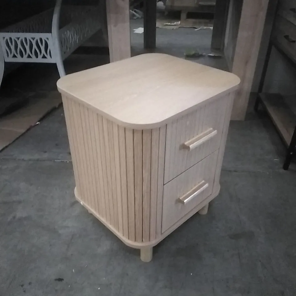 SUIRE LIGHT WOOD BEDSIDE TABLE, FEATURING ROUNDED CORNERS AND FLUTED DRAWER FRONTS