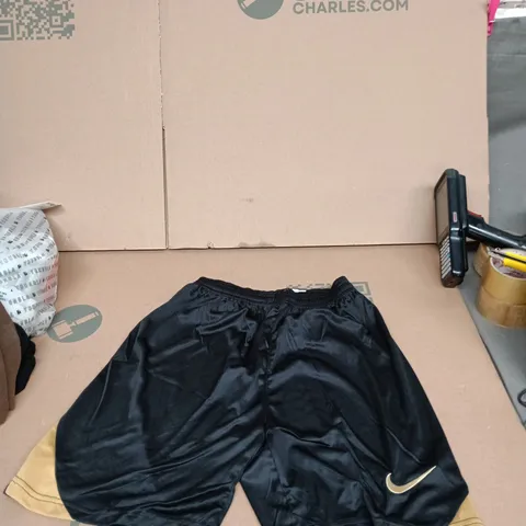 Nike black sports shorts with gold trim