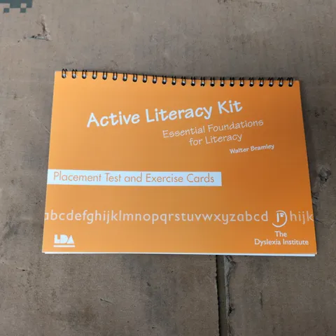 BOX OF APPROXIMATELY 30 BRAND NEW ACTIVE LITERACY KITS (PLACEMENT TEST AND EXERCISE CARDS)