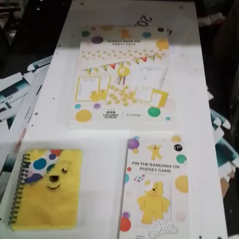 PALLET TO CONTAIN A LARGE QUANTITY OF PUDSEY PRODUCTS TO INCLUDE;PUDSEY BAKE OFF PARTY PACK,PIN THE BANDANA PUDSEY GAME,PUDSEY NOTEBOOKS