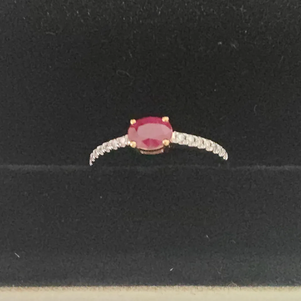 18CT GOLD RING SET WITH AN OVAL CUT RUBY AND DIAMONDS TO EACH SHOULDER WEIGHING +-0.66CT