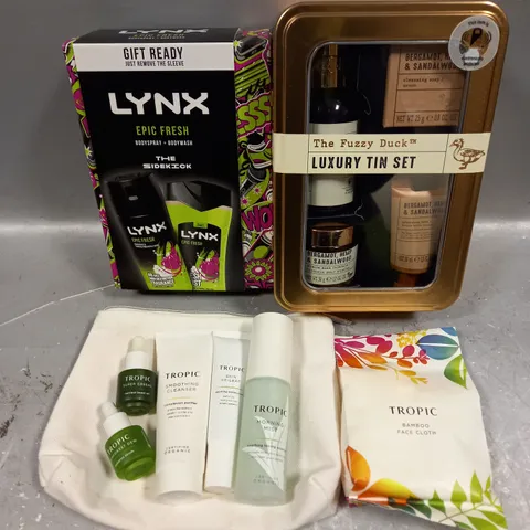 LOT OF 3 ASSORTED COSMETIC BOXSETS TO INCLUDE - LYNX EPIC FRESH BODY COLLECTION - THE FUZZY DUCK LUXURY TIN SET - TROPIC SKINCARE COLLECTION