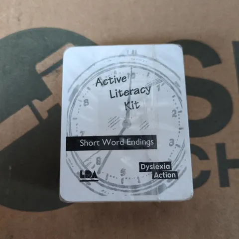 BOX OF APPROXIMATELY 130 BRAND NEW ACTIVE LITERACY KITS (SHORT WORD ENDINGS FLASH CARDS)