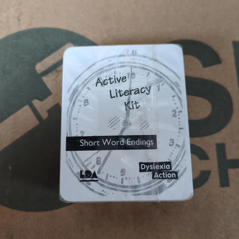 BOX OF APPROXIMATELY 130 BRAND NEW ACTIVE LITERACY KITS (SHORT WORD ENDINGS FLASH CARDS)