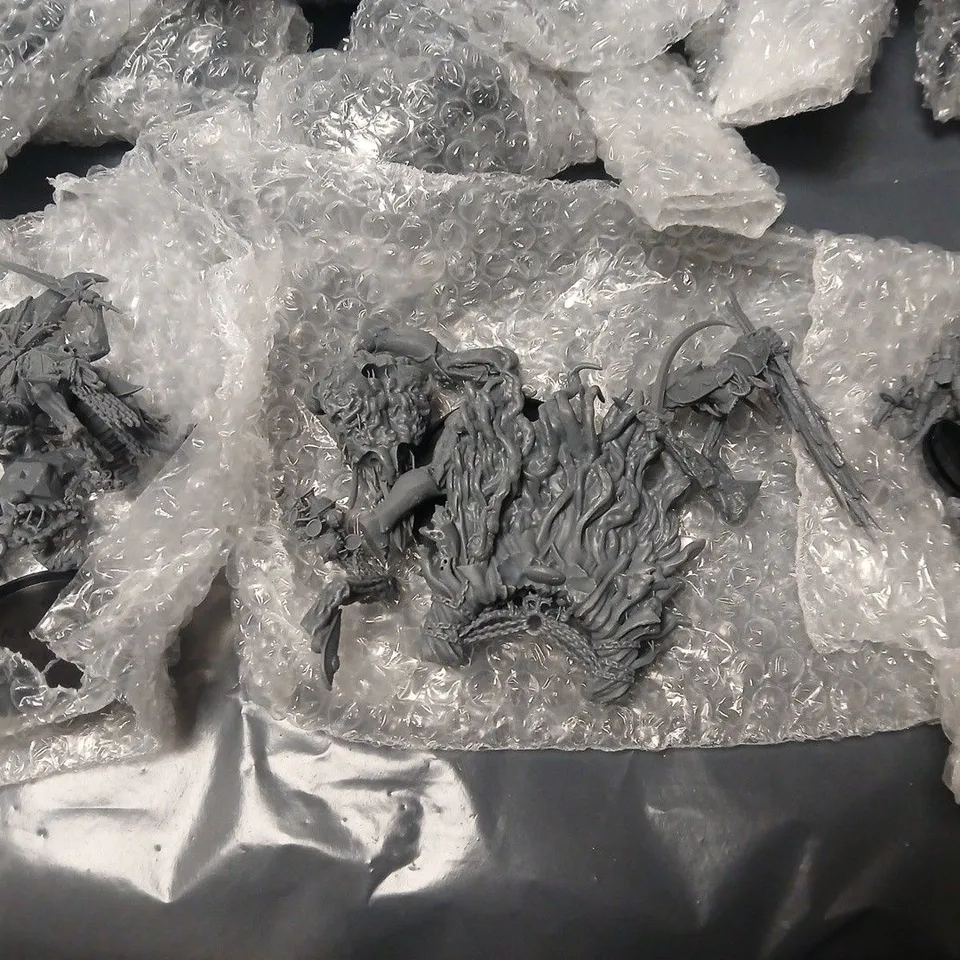 LOT OF ASSORTED WRAPPED UNPAINTED MINIATURE FIGURINES