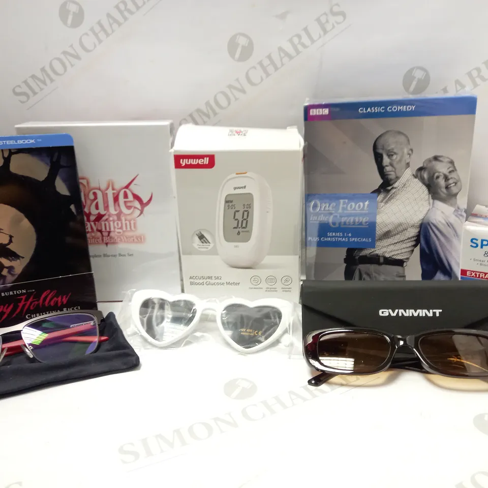 LOT OF APPROX 12 ASSORTED HOUSEHOLD ITEMS TO INCLUDE BLOOD GLUCOSE METER, BBC ONE FOOT IN THE GRAVE COLLECTION, PUMA GLASSES, ETC 