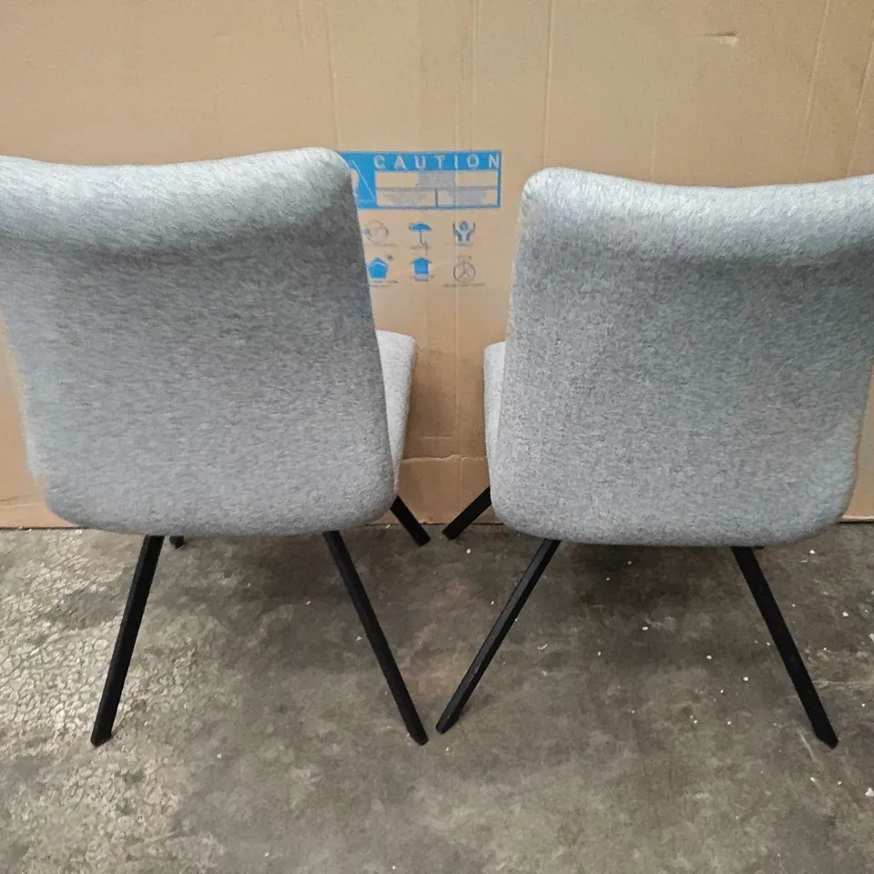 PAIR OF LIGHT GREY FABRIC ARMLESS DINING CHAIRS ON BLACK BASE