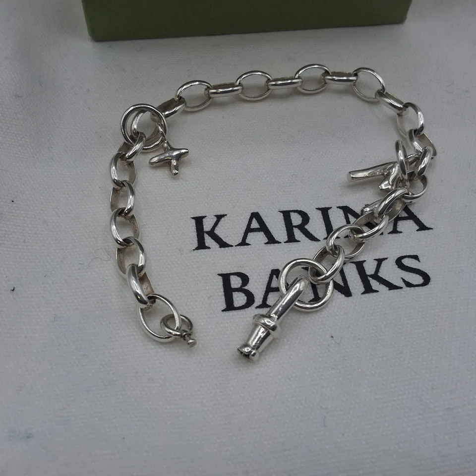 BOXED KARINA BANKS SILVER TONE BRACELET WITH CHARMS