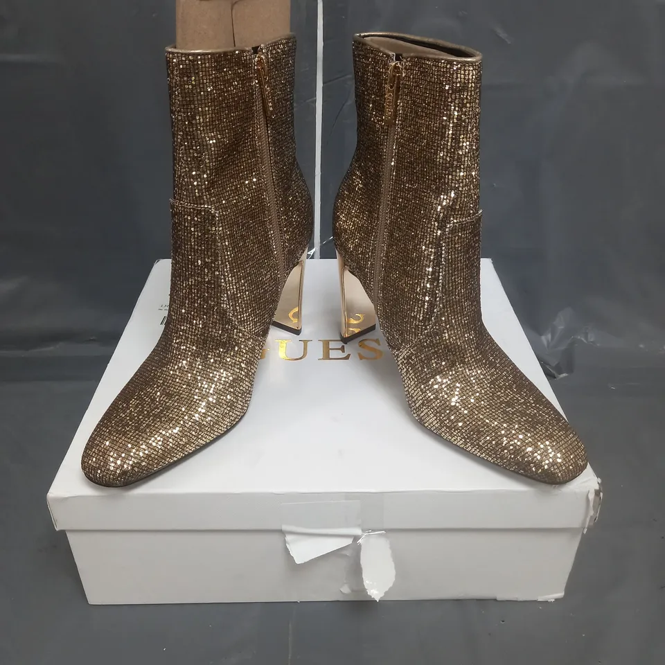 BOXED PAIR OF GUESS HEELED BOOTS IN GOLD SIZE 38