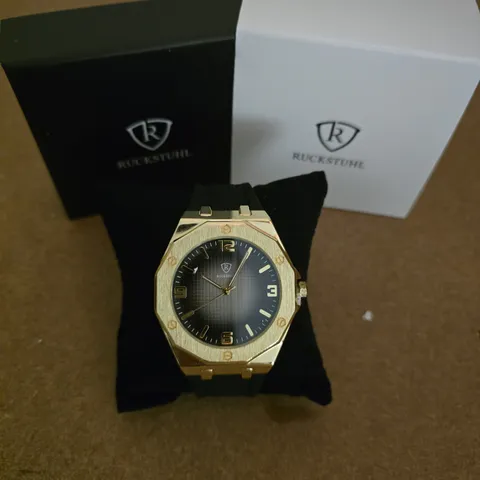 RUCKSTUHL WRISTWATCH – GOLD-TONE CASE, BLACK DIAL, BLACK RUBBER STRAP