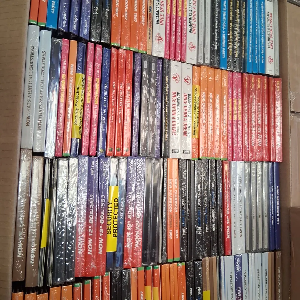APPROXIMATELY 100 BRAND NEW CDS TO INCLUDE; THE BEATLES, DREAMBOATS AND PETTICOATS, TAYLOR SWIFT AND NOW