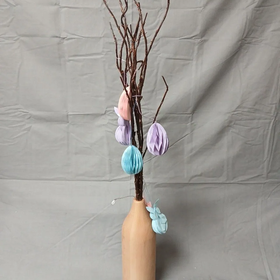 Decorative twig tree in wooden vase with pastel honeycomb ornaments