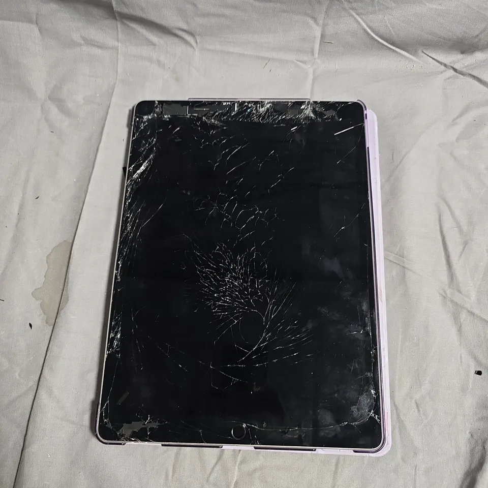 TABLET COMPUTER WITH CRACKED SCREEN IN PURPLE CASE - MODEL UNSPECIFIED 