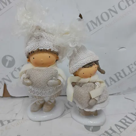 STANDING BOY AND GIRL WITH LARGE HEARTS