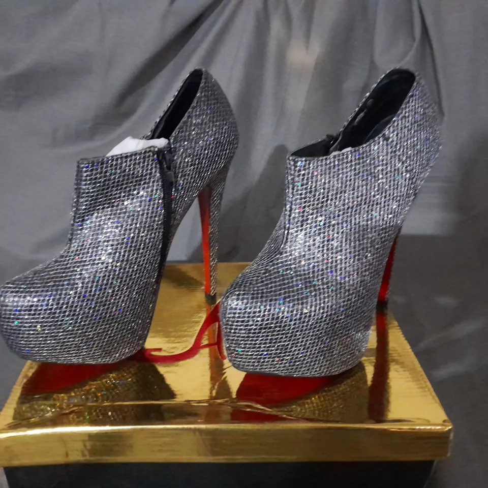 APPROXIMATELY 10 BOXED PAIRS OF SILVER HIGH HEEL BOOTS VARIOUS SIZES