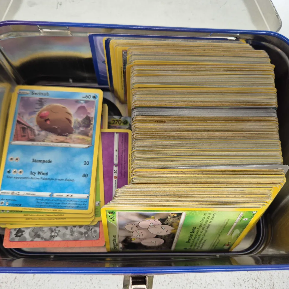 POKEMON TEAM ROCKET TIN WITH ASSORTMENT OF POKEMON CARDS