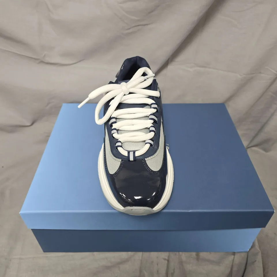 BOXED PAIR OF CLEENS PODIUM TRAINERS IN INDIGO - UK 7.5