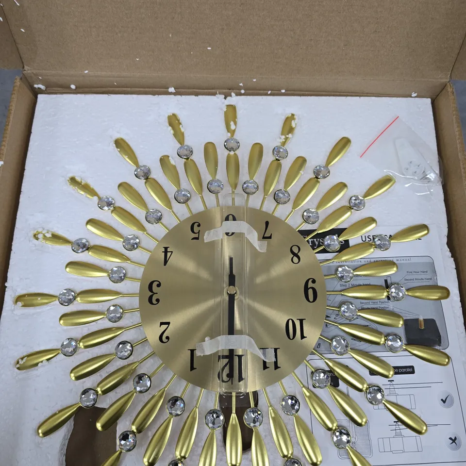 GOLD TONE SUNBURST WALL CLOCK WITH CRYSTAL ACCENTS