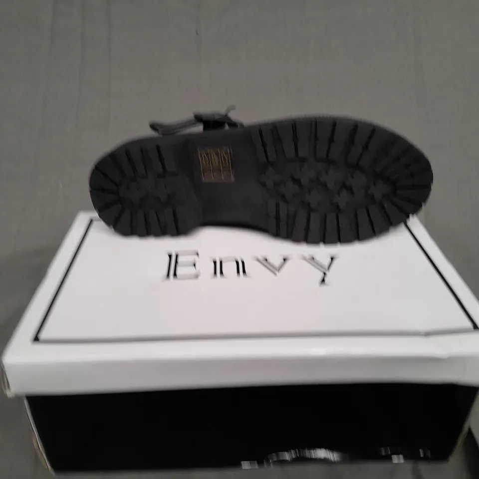 BOXED PAIR OF ENVY SIZE 31 BLACK PATENT BUCKLE TRAINER 