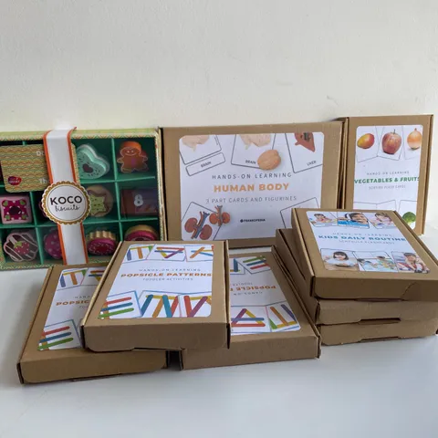 BOX OF 9 BRAND NEW ITEMS TO INCLUDE: KOCO BISCUITS SET, HUMAN BODY SET, KIDS DAILY ROUTINE SETS ETC