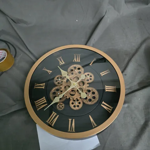 BRONZE SKELETON WALL CLOCK WITH EXPOSED GEARS AND ROMAN NUMERALS