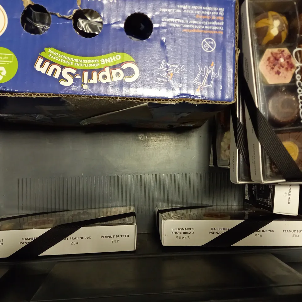 TOTE OF APPROX 11 ASSORTED FOOD ITEMS TO INCLUDE - CAPRI-SUN ORANGE , PRIME UFC , HOTEL CHOCOLAT ETC