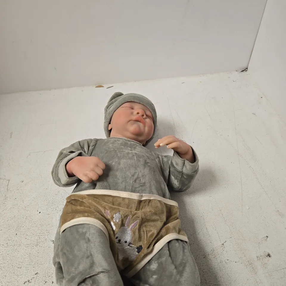 SOFT-BODIED BABY DOLL WITH GREY OUTFIT AND HAT