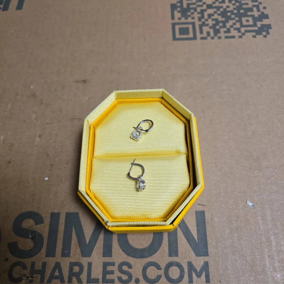 SWAROVSKI TWO SMALL SILVER-TONE EARRINGS WITH CLEAR STONES IN YELLOW OCTAGONAL PRESENTATION BOX