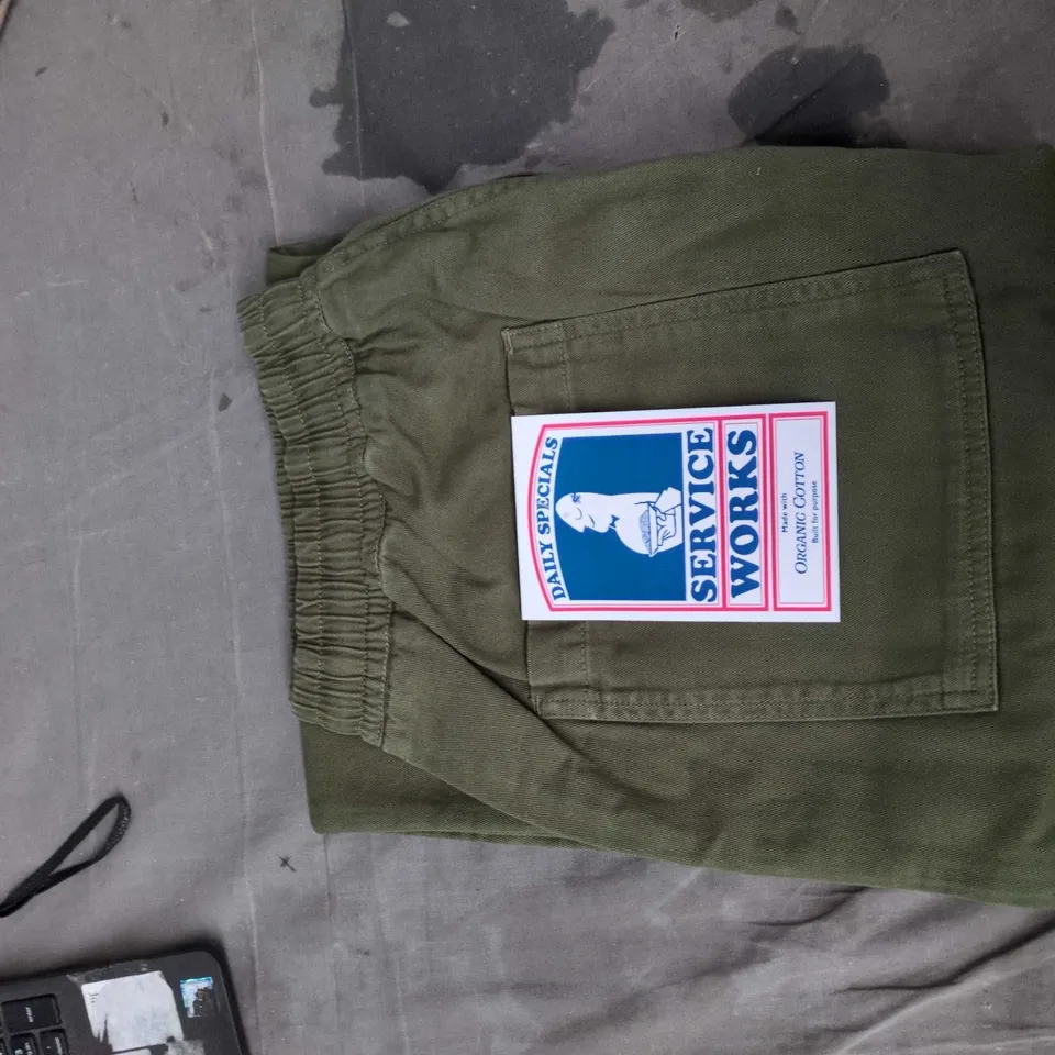 BOX OF APPROXIMATELY 25 ASSORTED CLOTHING ITEMS TO INCLUDE:  XPLOSIVE APE TSHIRT AND GREEN WORK PANTS